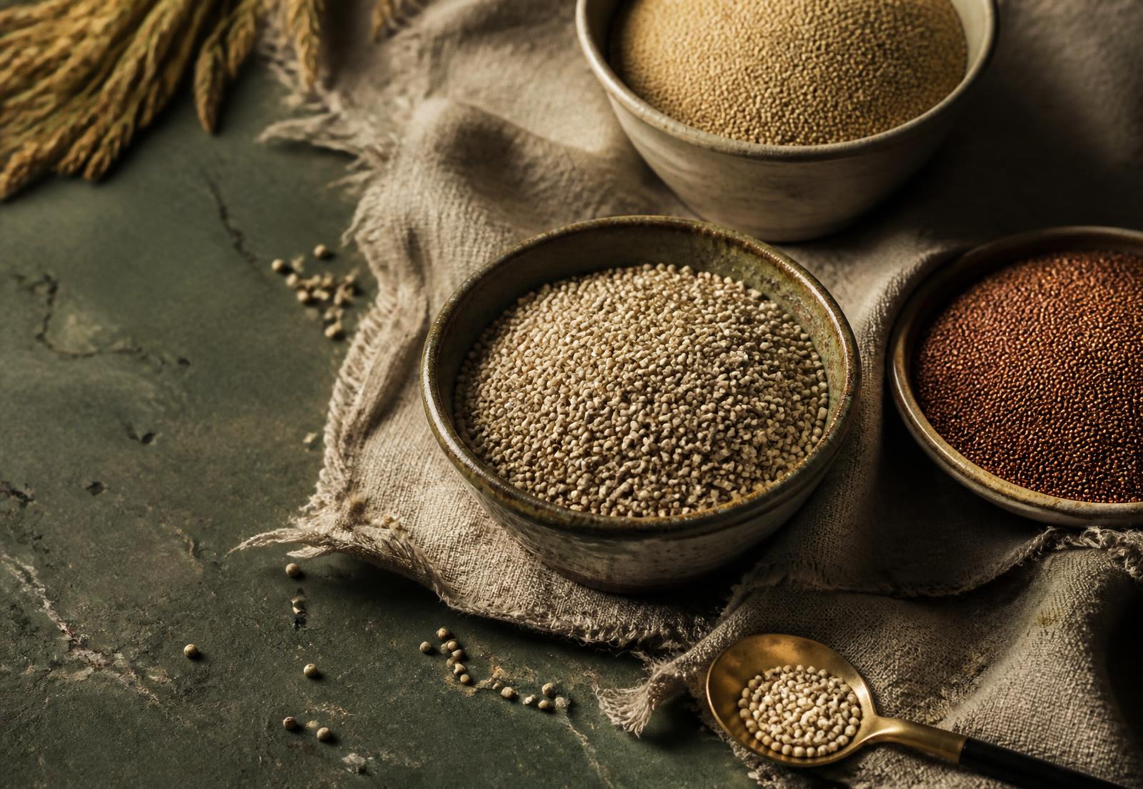 Clay bowls of pearl, foxtail and finger millet on a linen cloth